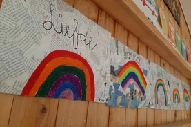 A vibrant wall featuring colorful rainbow artwork.